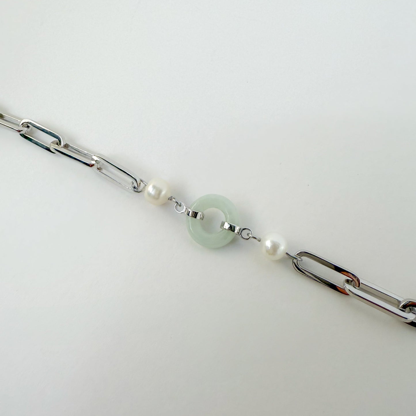 Beauty and Affluence Bracelet with Grade A Burmese jade and freshwater pearls in 14k white gold, flat lay - Crowned