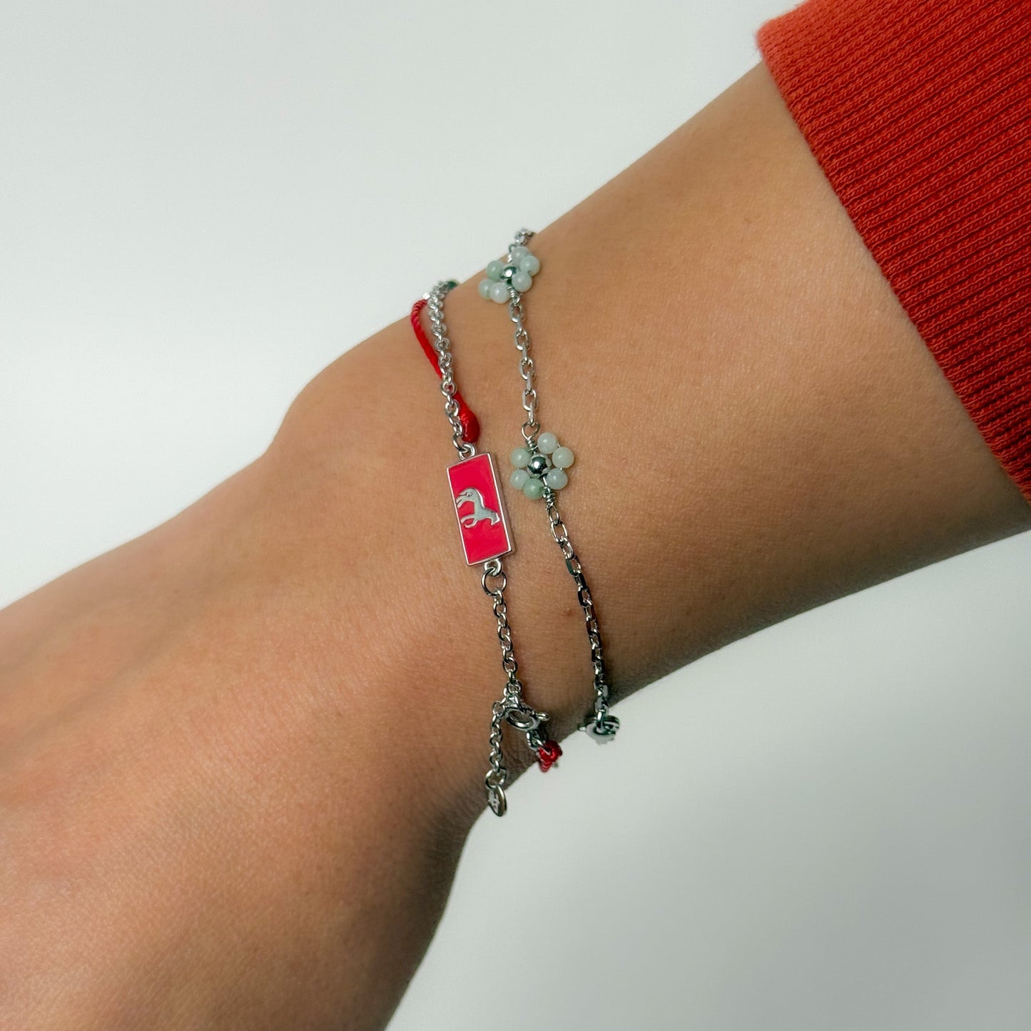 Horse zodiac red string bracelet with white gold chain, flat lay - Crowned
