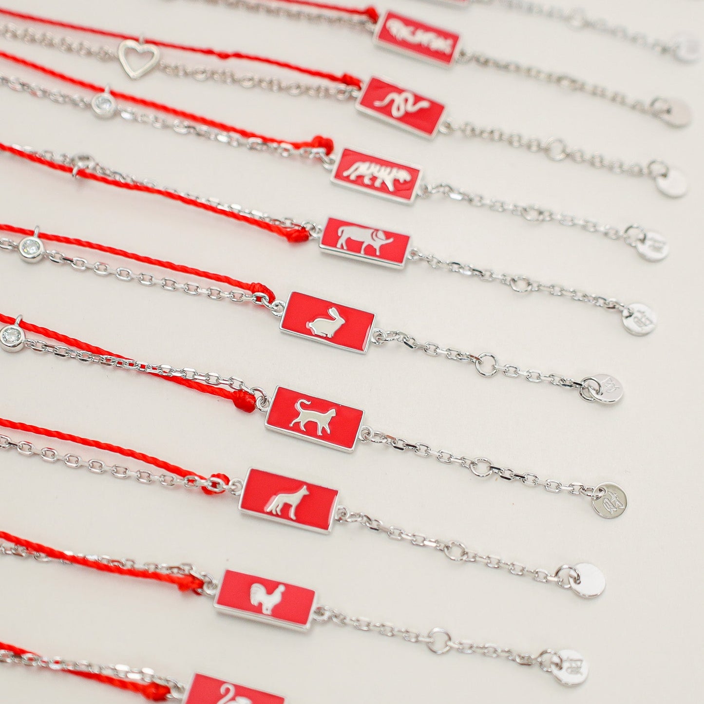 Cat zodiac red string bracelet with silver chain, wrist view - Crowned