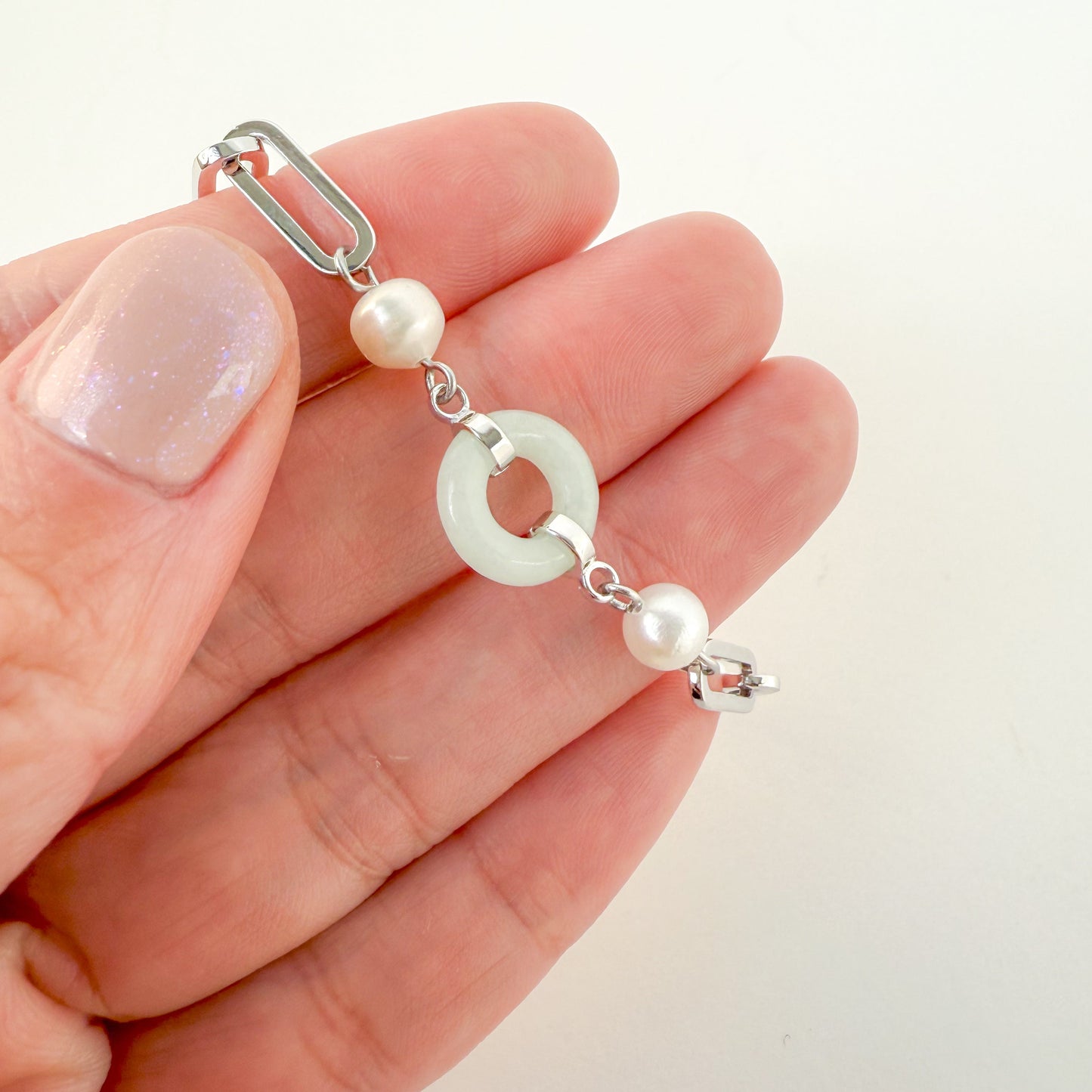 Beauty and Affluence Bracelet with Grade A Burmese jade and freshwater pearls in 14k white gold, flat lay - Crowned