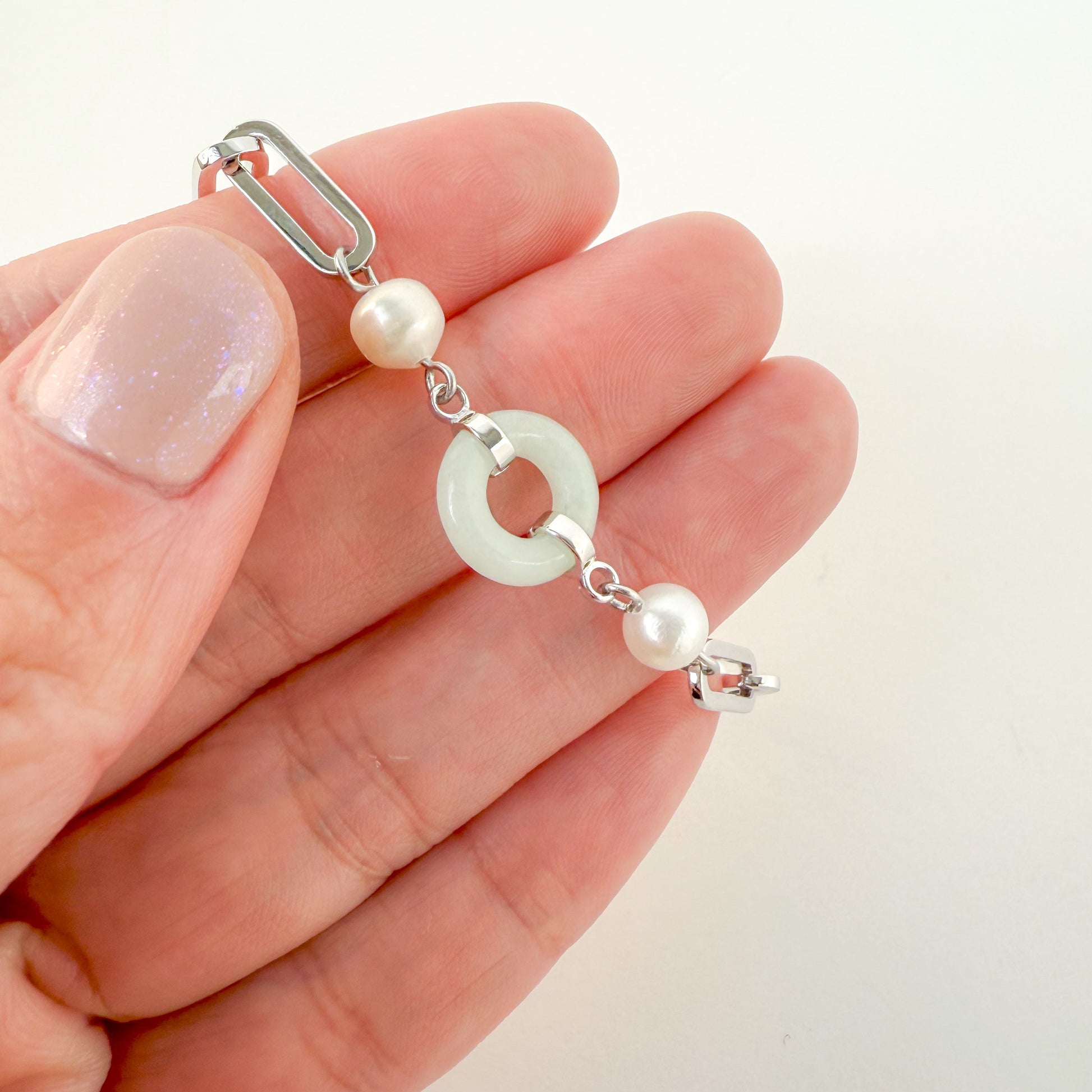 Beauty and Affluence Bracelet with Grade A Burmese jade and freshwater pearls in 14k white gold, flat lay - Crowned
