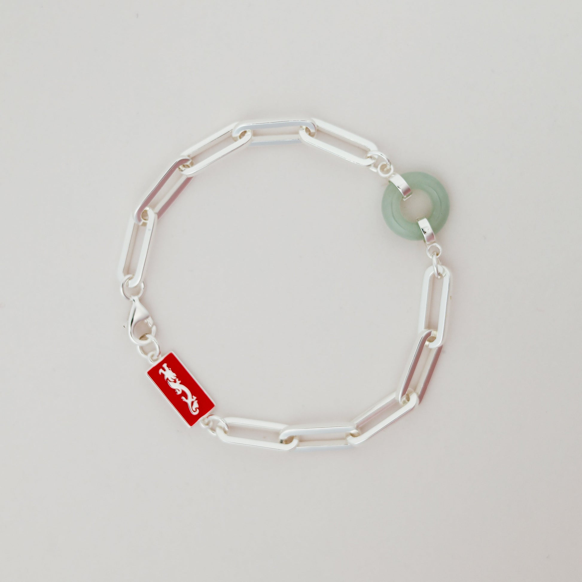 Dragon Happiness and Wealth Bracelet with Grade A Burmese jade, white gold, flat lay - Crowned