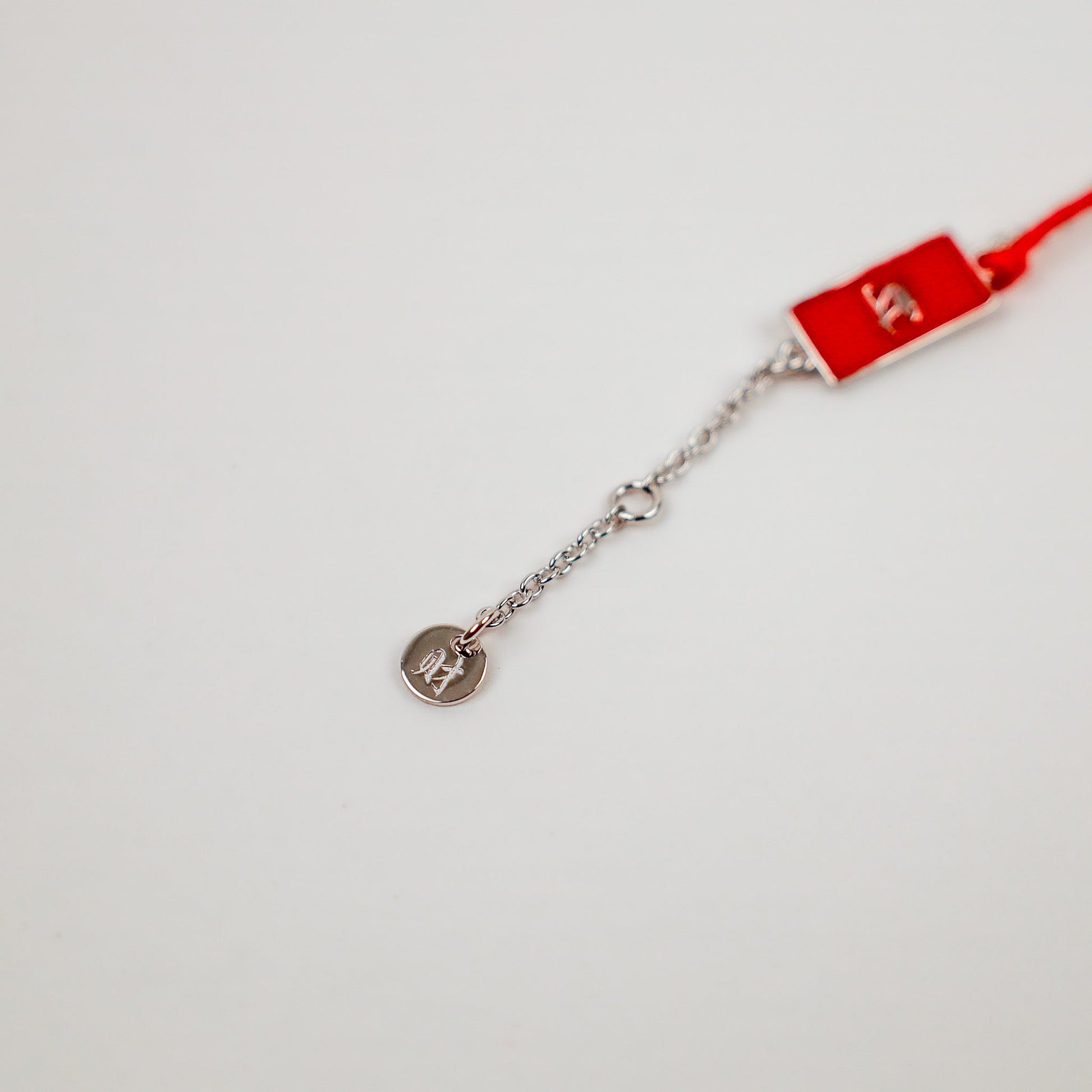 Gold Red String Good Luck Bracelet in 14k white gold, flat lay - Crowned jewelry