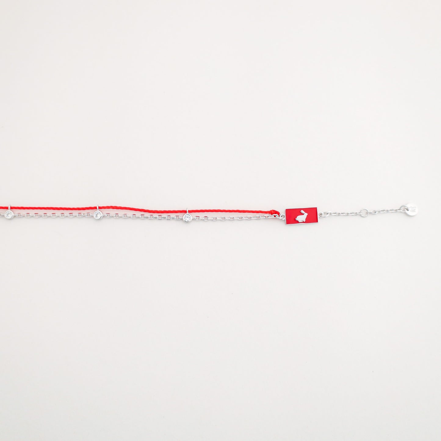 Rabbit zodiac red string bracelet with silver chain, wrist view - Crowned