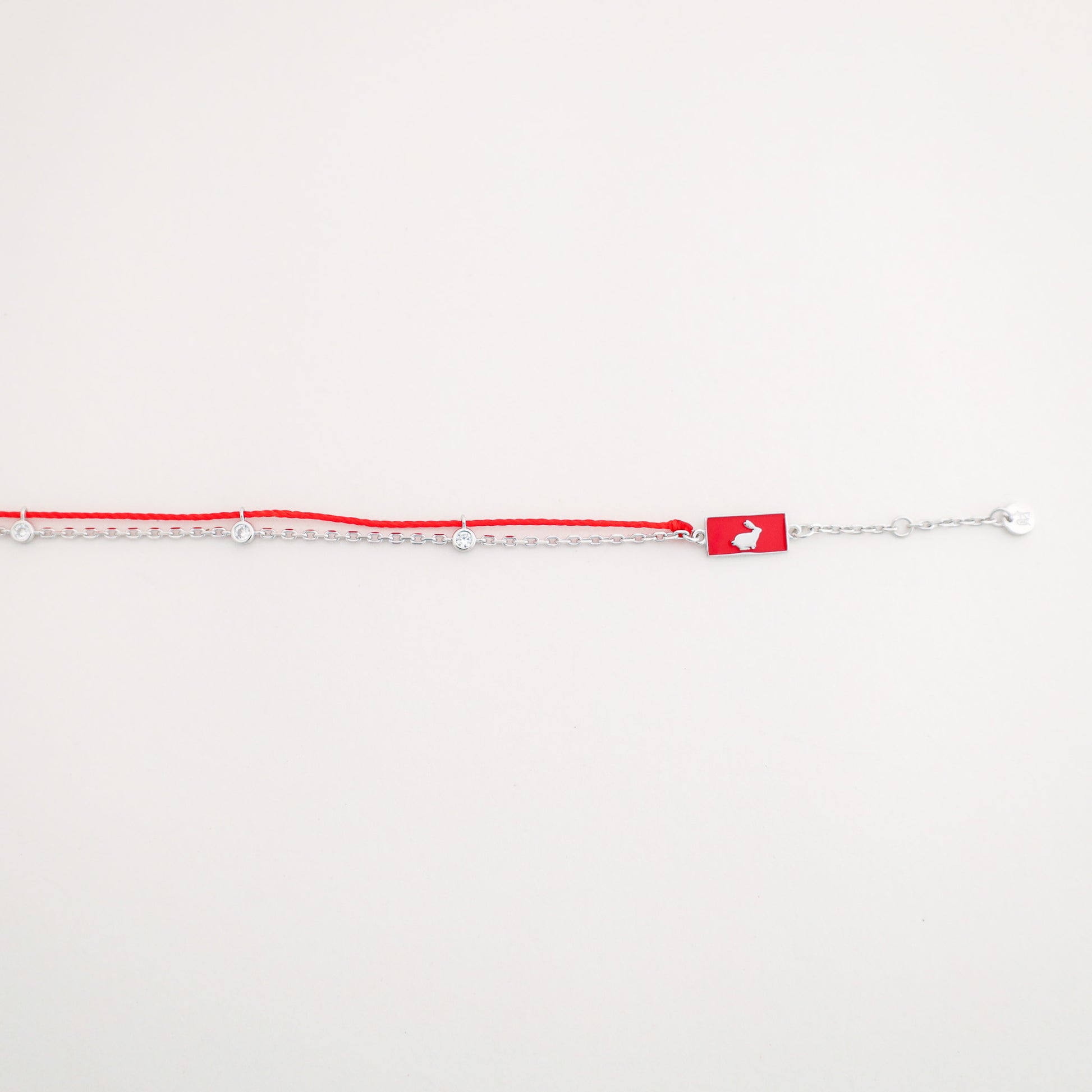 Rabbit zodiac red string bracelet with silver chain, wrist view - Crowned