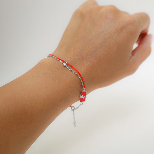 Rabbit zodiac red string bracelet with white gold chain, flat lay - Crowned