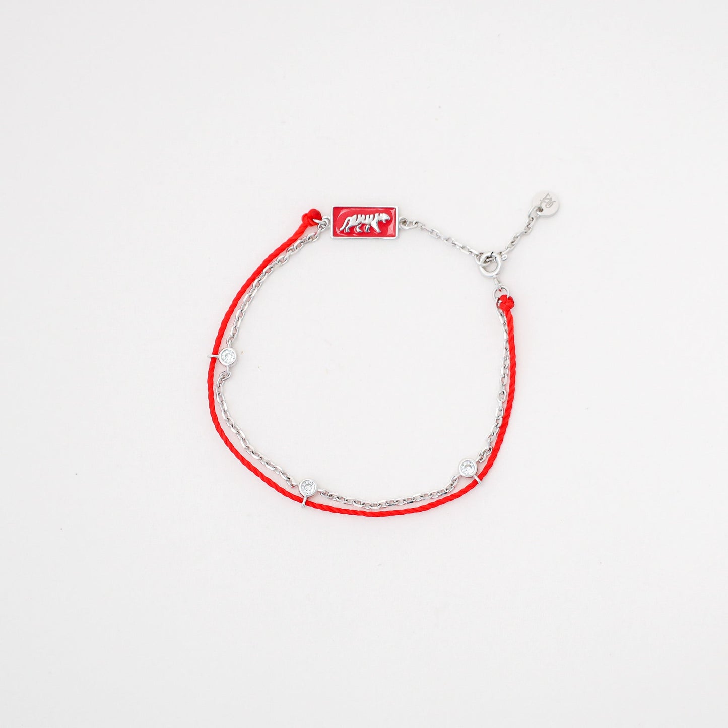 Tiger zodiac red string bracelet with white gold chain, flat lay - Crowned