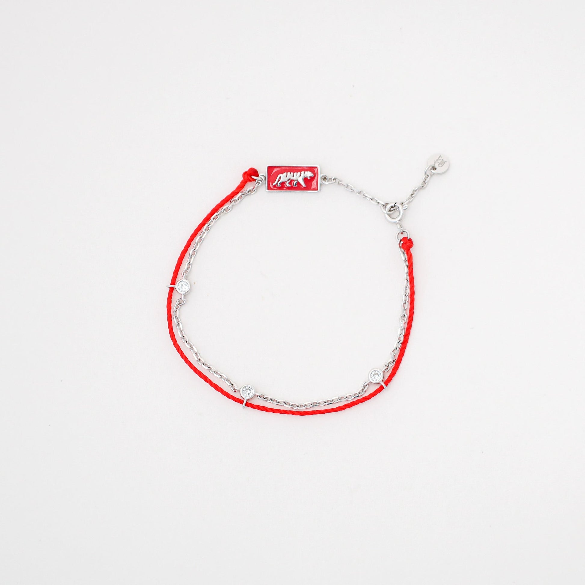 Tiger zodiac red string bracelet with white gold chain, flat lay - Crowned