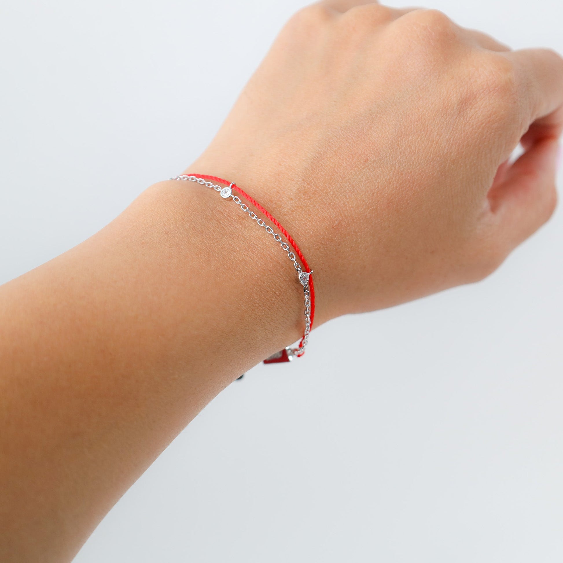 Tiger zodiac red string bracelet with white gold chain, flat lay - Crowned