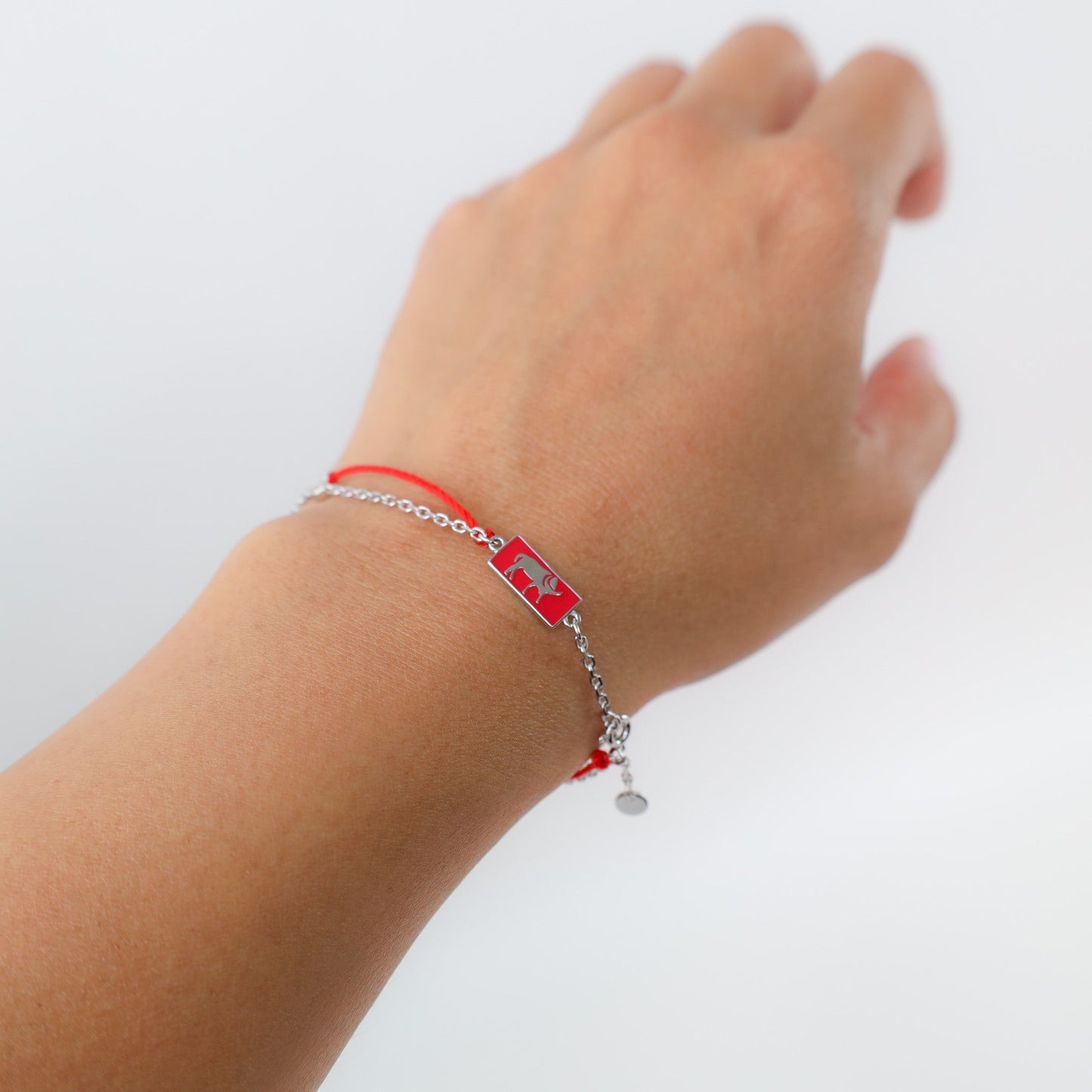 Ox zodiac red string bracelet with white gold chain, flat lay - Crowned