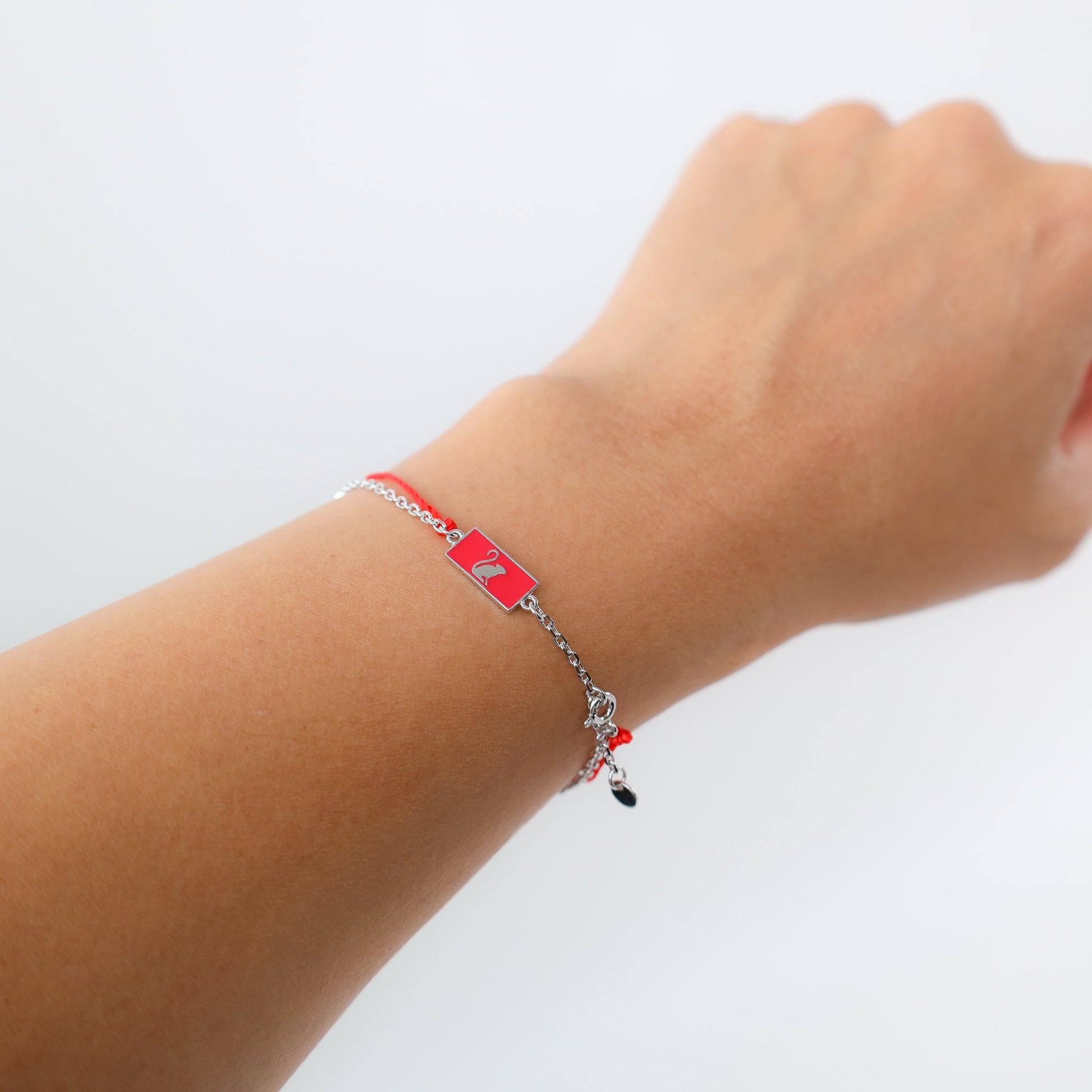 Monkey zodiac red string bracelet with white gold chain, flat lay - Crowned