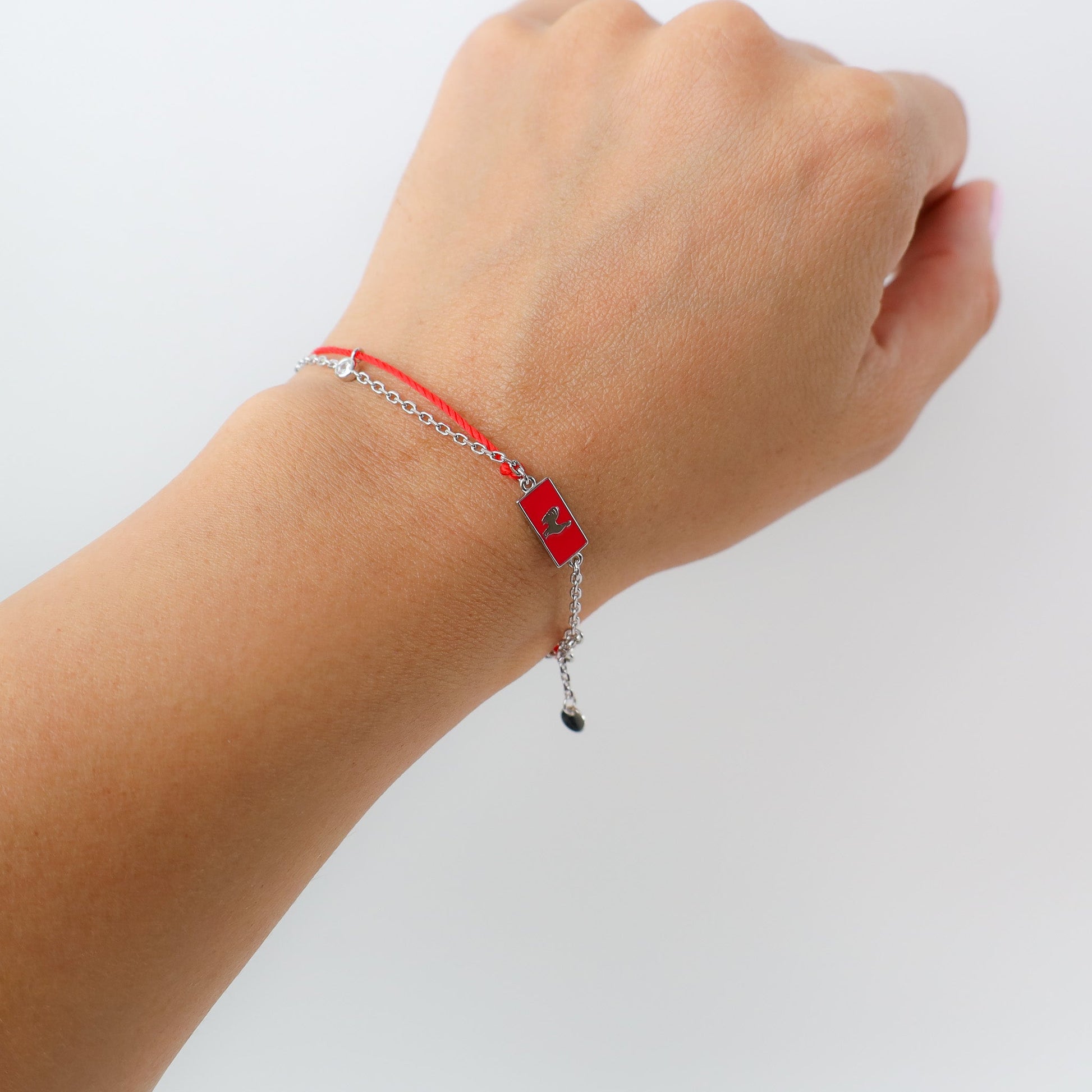 Rooster zodiac red string bracelet with white gold chain, flat lay - Crowned