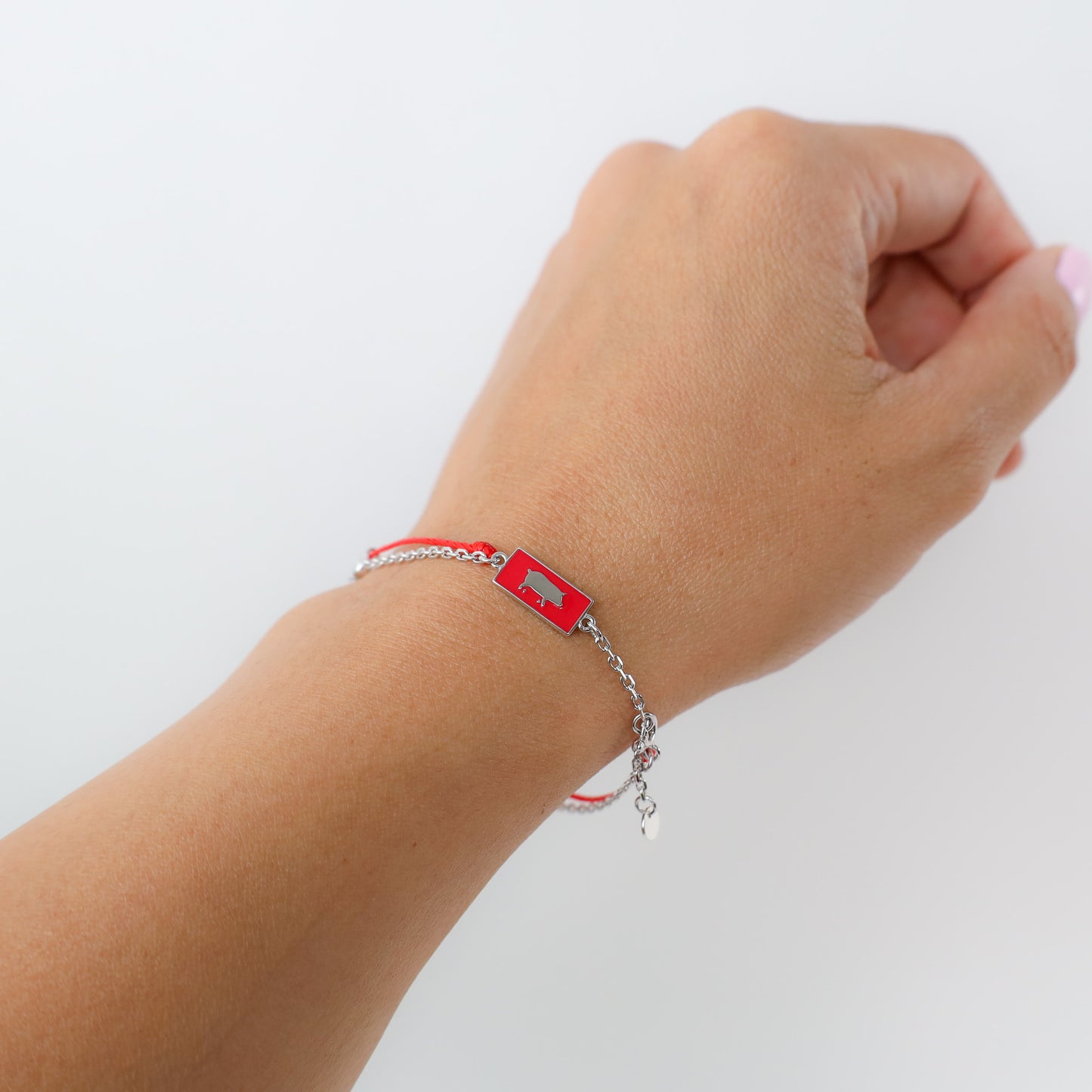 Pig zodiac red string bracelet with silver chain, lifestyle shot - Crowned