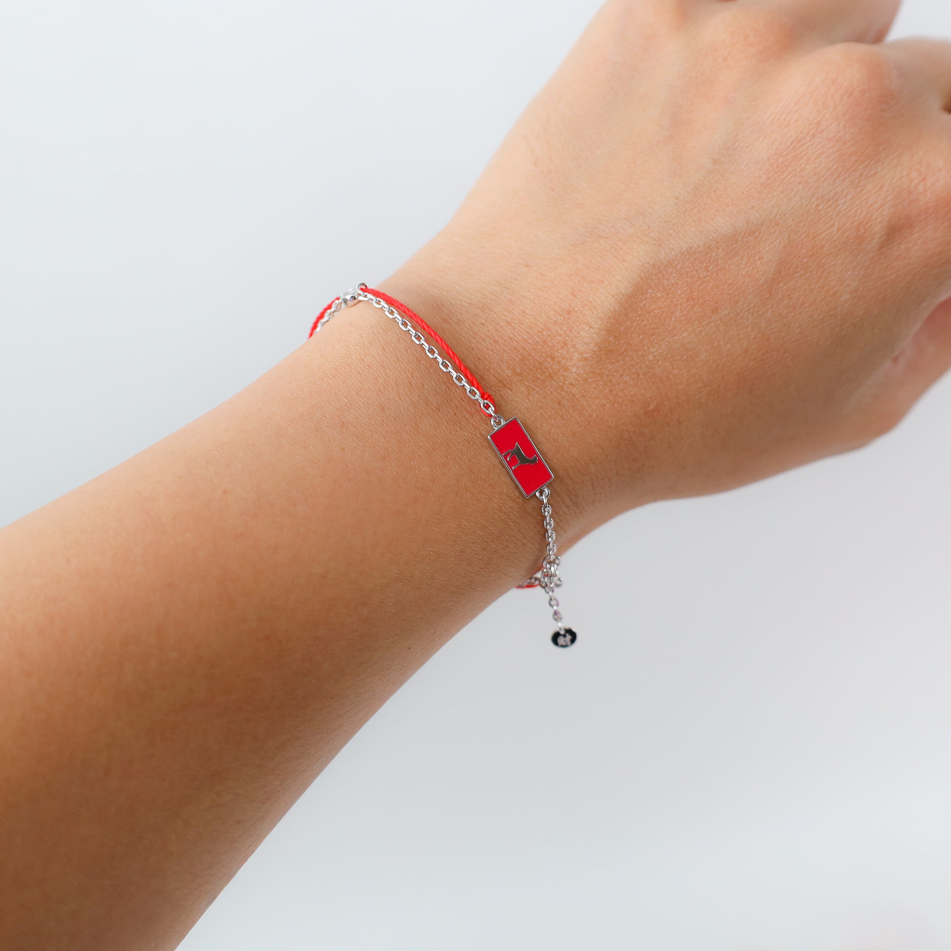 Goat zodiac red string bracelet with silver chain, lifestyle shot - Crowned