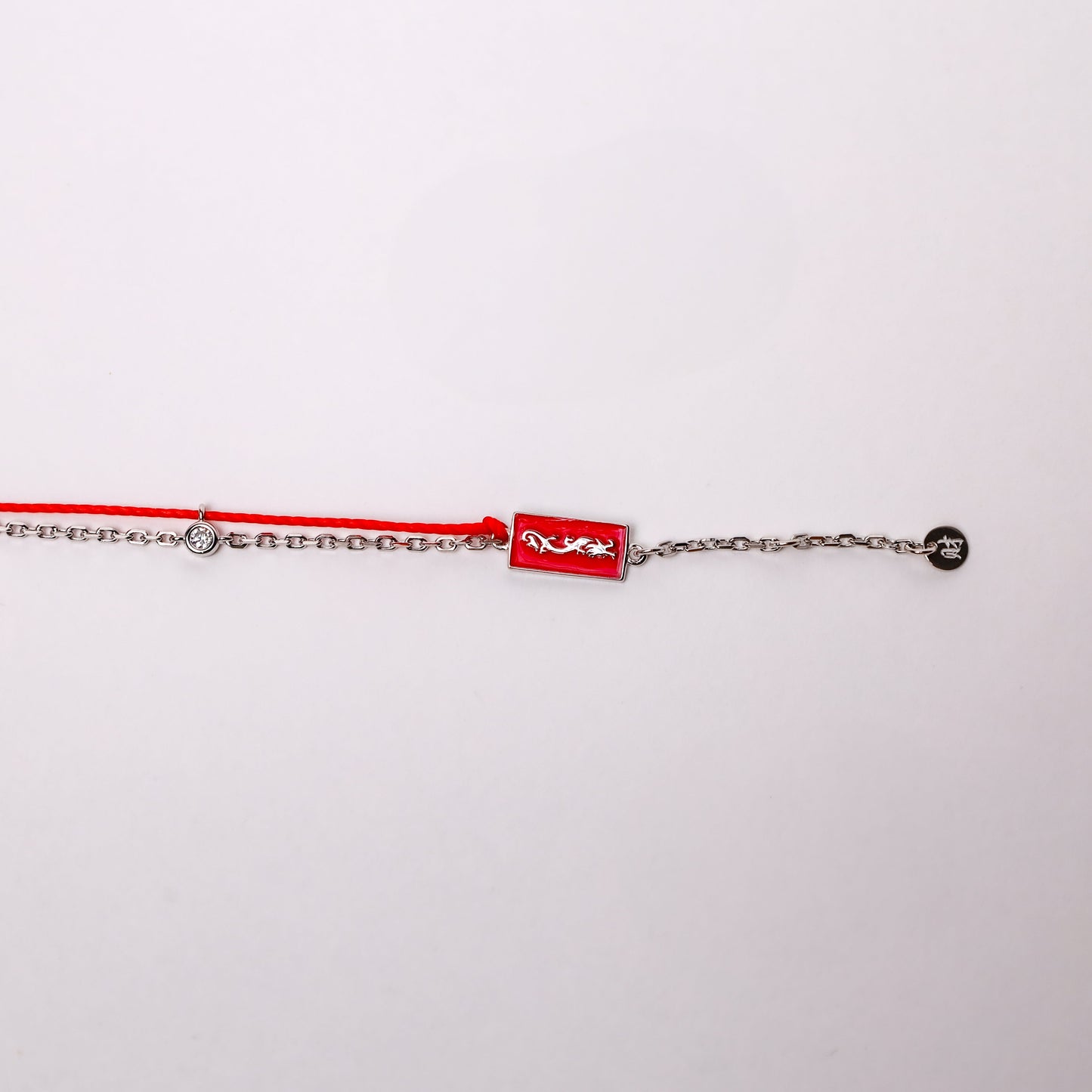 Dragon zodiac red string bracelet with white gold chain, flat lay - Crowned