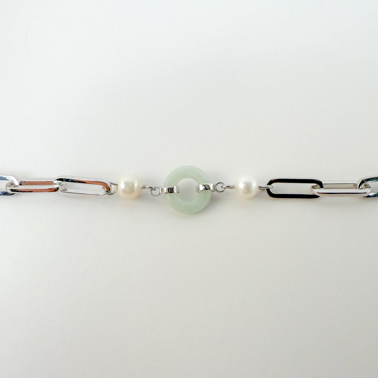 Beauty and Affluence Bracelet with Grade A Burmese jade and freshwater pearls in 14k white gold, flat lay - Crowned