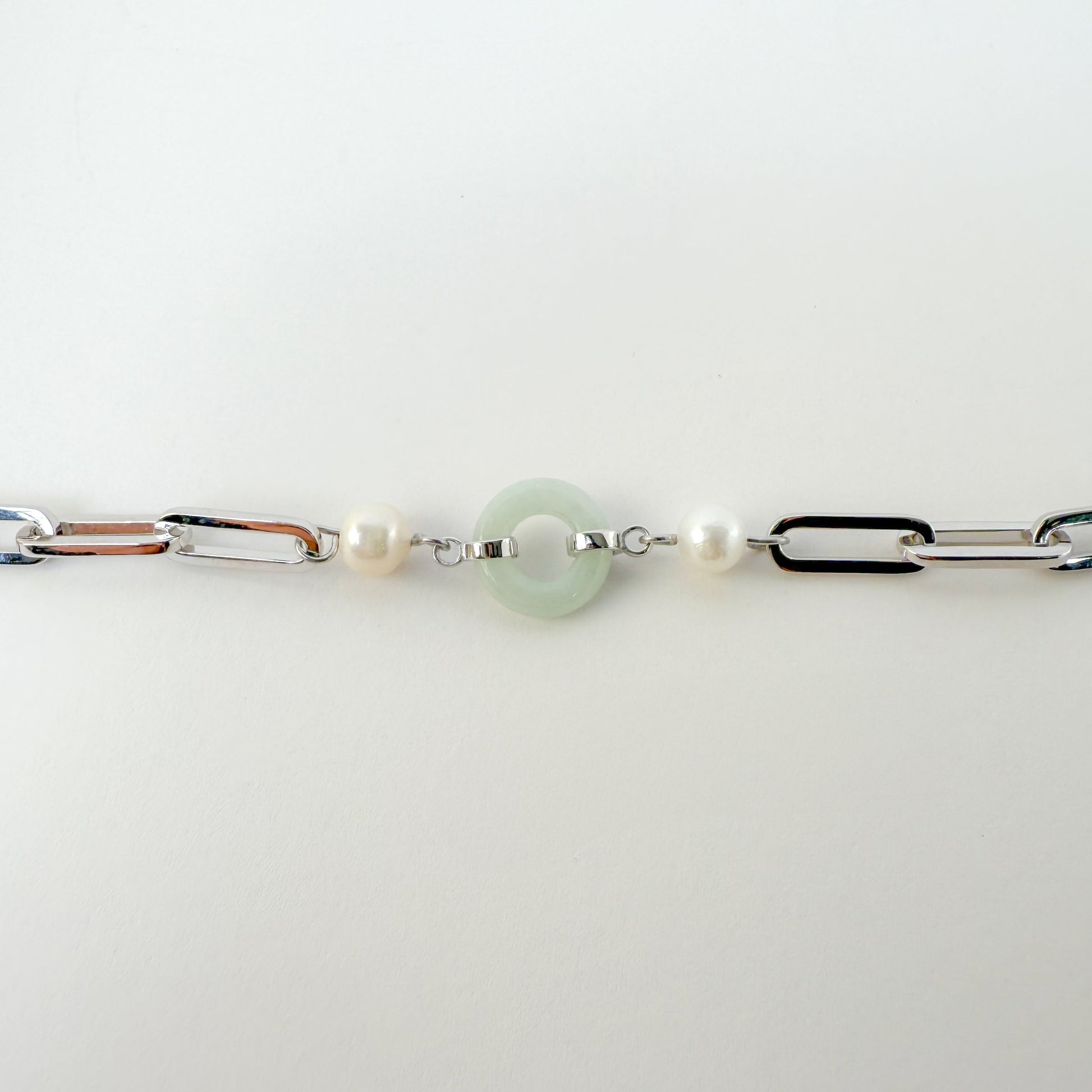 Beauty and Affluence Bracelet with Grade A Burmese jade and freshwater pearls in 14k white gold, flat lay - Crowned