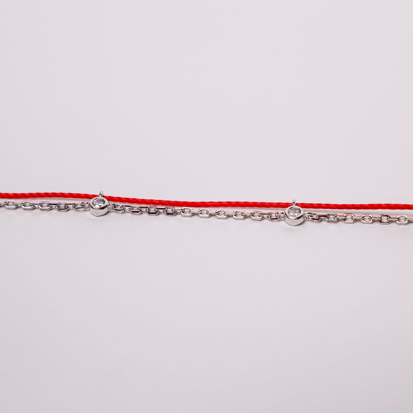 Dragon zodiac red string bracelet with white gold chain, wrist view - Crowned