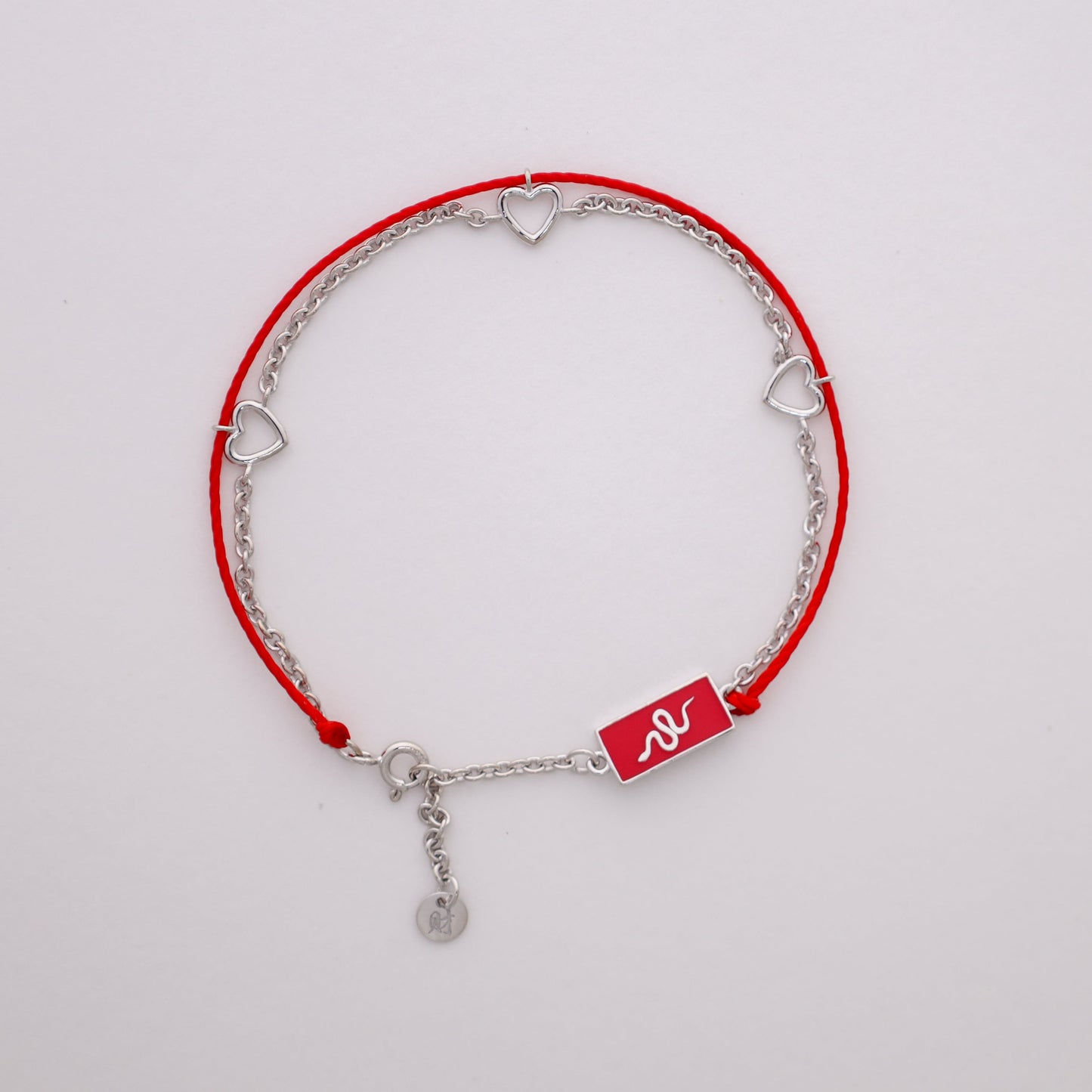 Snake zodiac red string bracelet with white gold chain, flat lay - Crowned