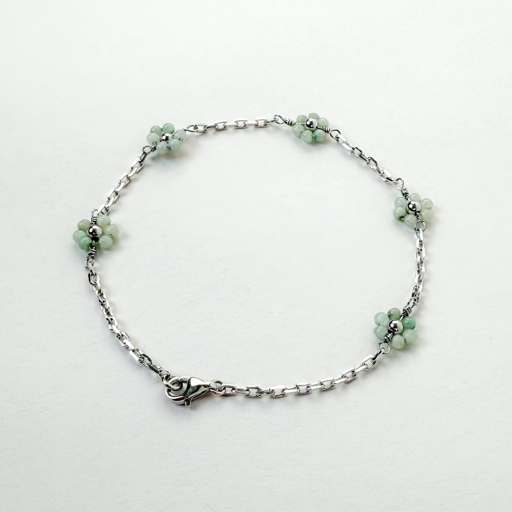 Harmony and Joy Bracelet with Grade A Burmese jade flower, white gold, lifestyle shot - Crowned