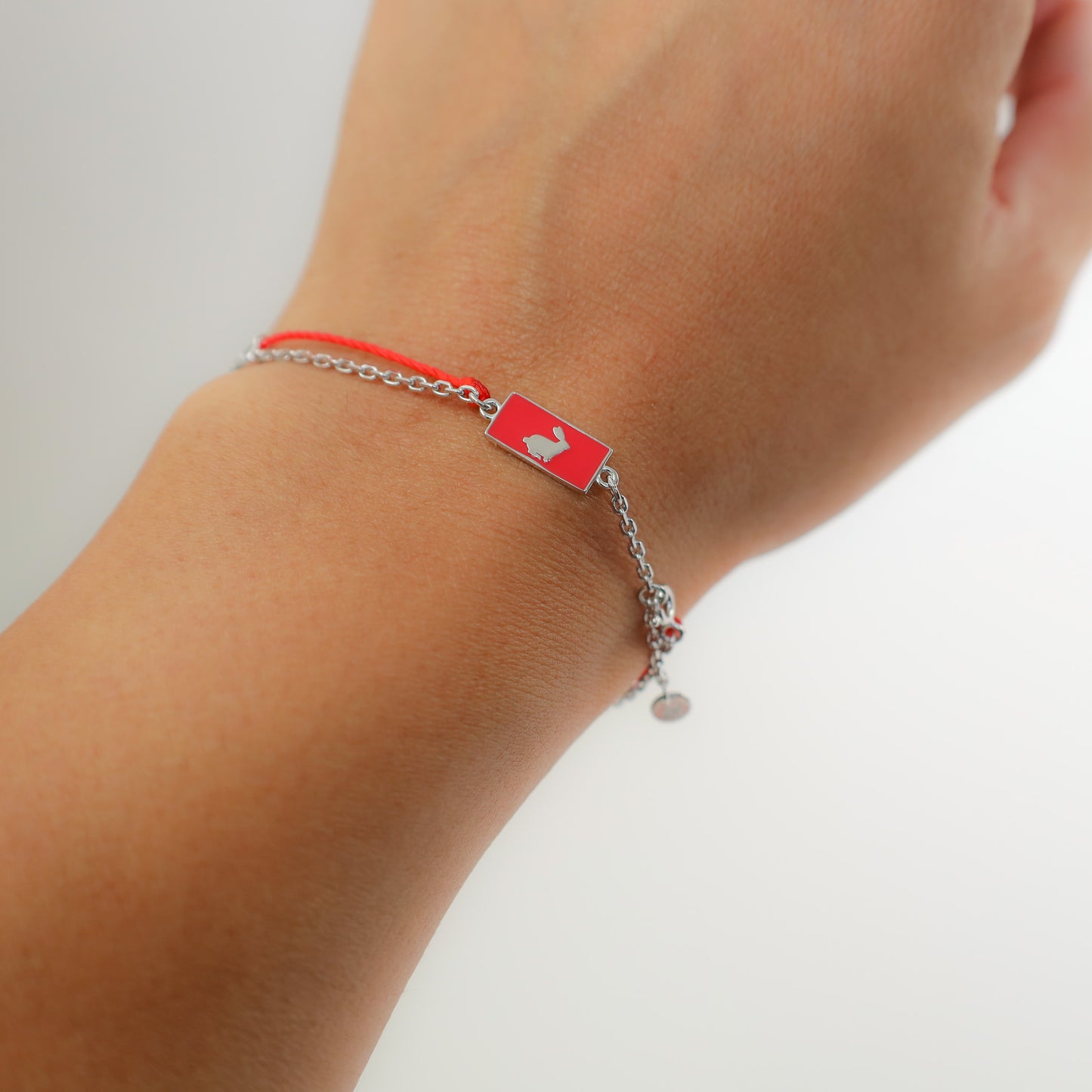 Rabbit zodiac red string bracelet with silver chain, close-up detail - Crowned