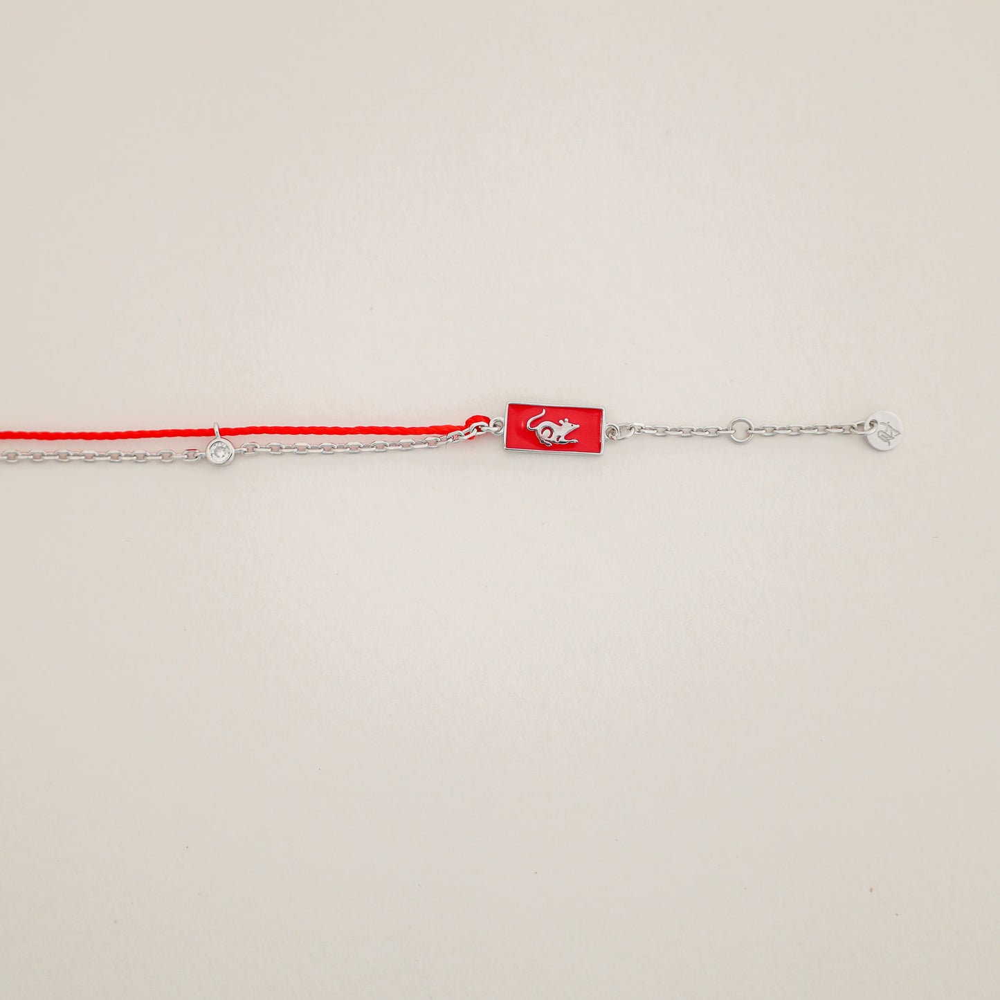 Rat zodiac red string bracelet with silver chain, wrist view - Crowned
