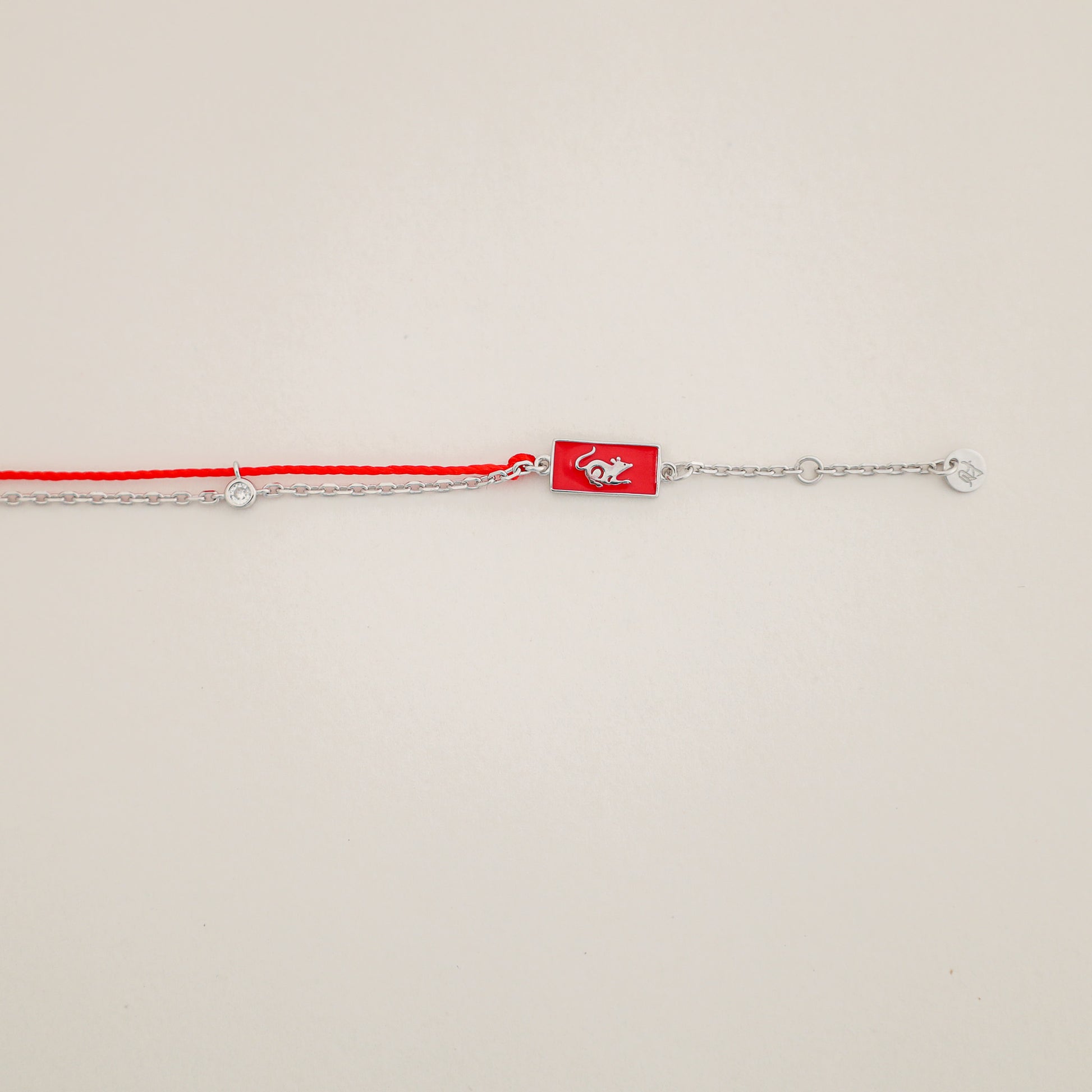 Rat zodiac red string bracelet with silver chain, wrist view - Crowned