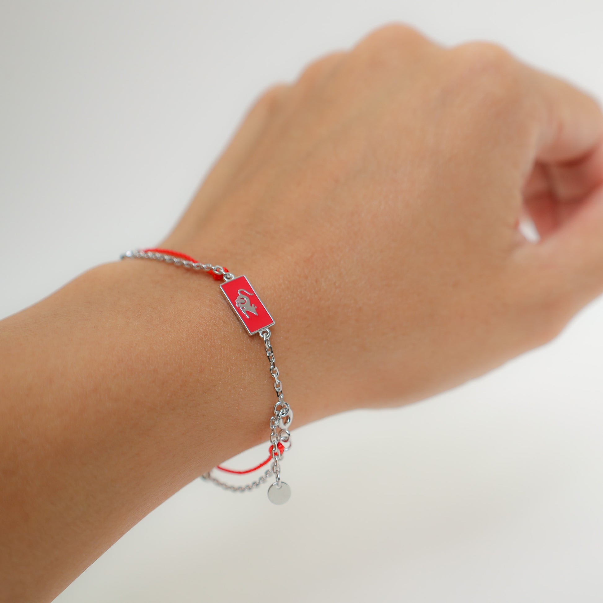 Rat zodiac red string bracelet with silver chain, lifestyle shot - Crowned